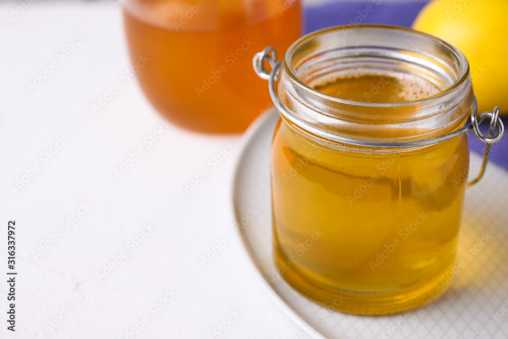 Tasty aromatic honey on white table, closeup