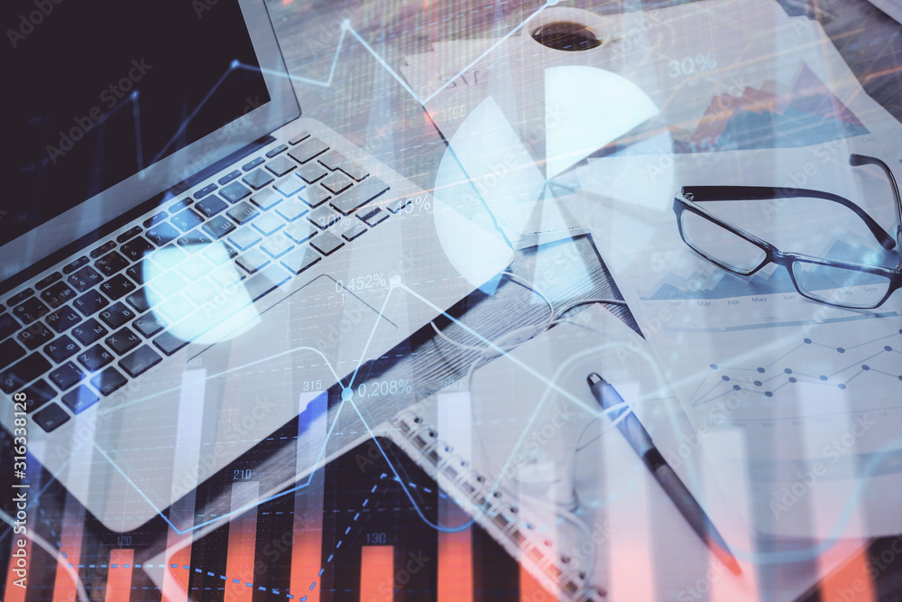 Forex Chart hologram on table with computer background. Double exposure. Concept of financial markets. Forex Chart hologram on table with computer background. Double exposure. Concept of financial markets.
