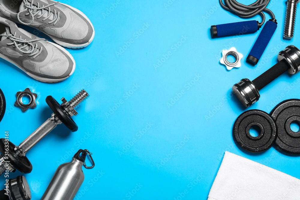 Gym equipment on light blue background, flat lay. Space for text - obrazy, fototapety, plakaty 