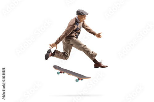 Energetic elderly man jumping with a skateboard