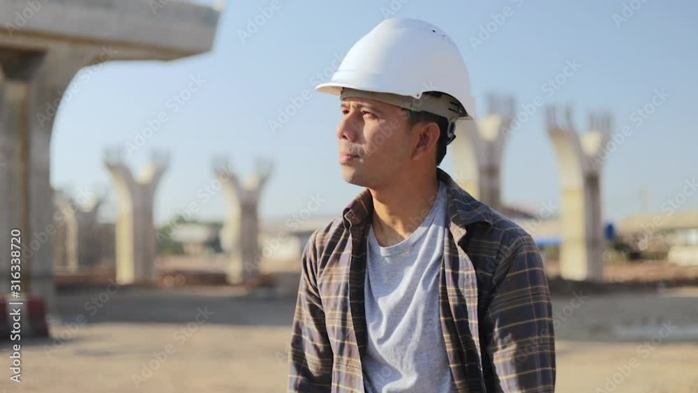 Engineers Construction walking and holds blueprint in construction site. Engineers Construction walking and holds blueprint in construction site.