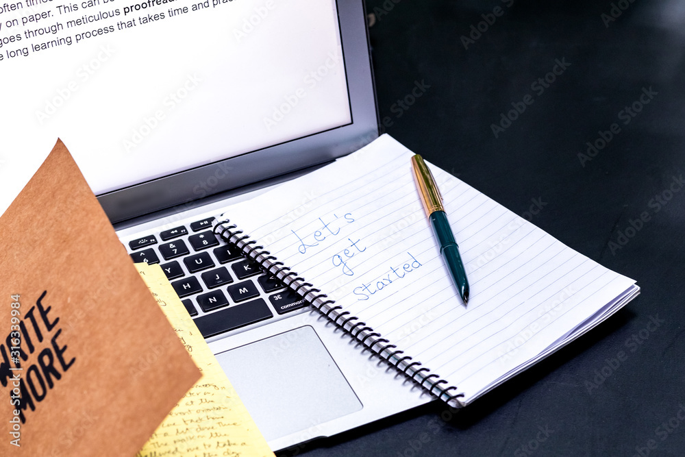 Blogger concept. There is a pc laptop with notebook and pen at a table in a cafe. selective focus Blogger concept. There is a pc laptop with notebook and pen at a table in a cafe. selective focus