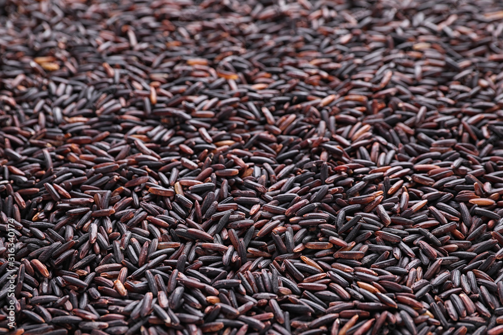 Uncooked organic brown rice as background, closeup Uncooked organic brown rice as background, closeup