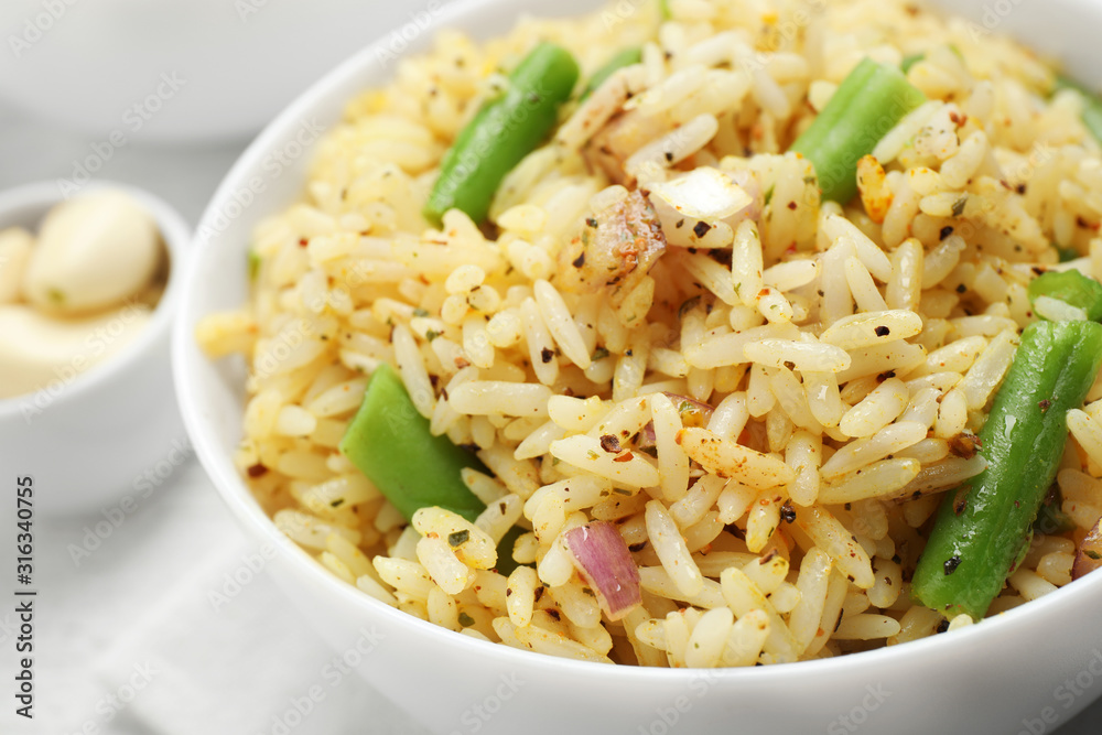 Tasty rice pilaf with vegetables on table, closeup
