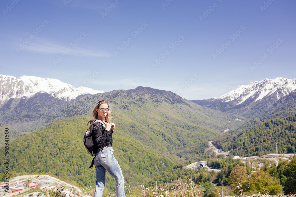 Portrait of a beautiful young girl lover and protector of the environment and trekking goes to picturesque places in the mountains. Concept of Unity with nature, ecotourism