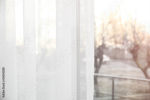 Window with white curtains indoors, closeup view