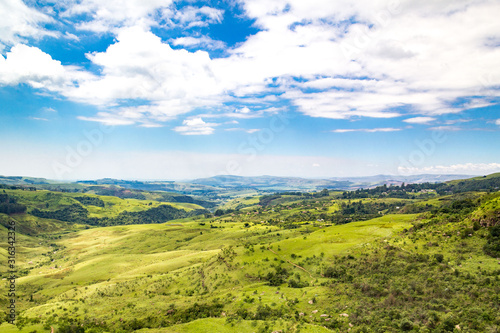 Panoramic view over a green and vast valley on a sunny day  Drakensberg  Giants Castle Game Reserve  South Africa