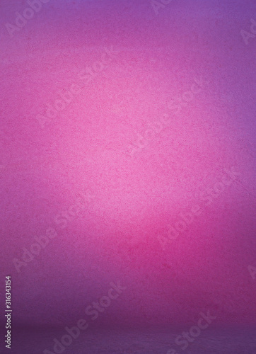 Photographic studio background vertical with soft vignette light pink with purple. Soft gradient background. Painted canvas or muslin cloth wall and floor studio backdrop