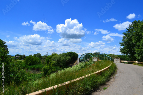 Beautiful clouds over the plain Bridge to Lukino Selo