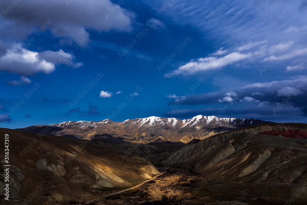 Wide angle panoramic view of the mountain peaks covered with snow