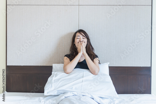 depress woman sitting on bed in room with hand on her mouth, sadness and depress concept