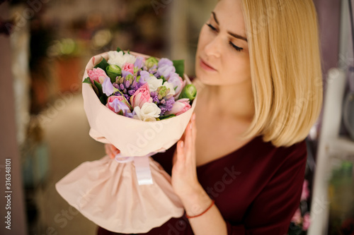 Cute girl holding a beautiful and colorful bouquet