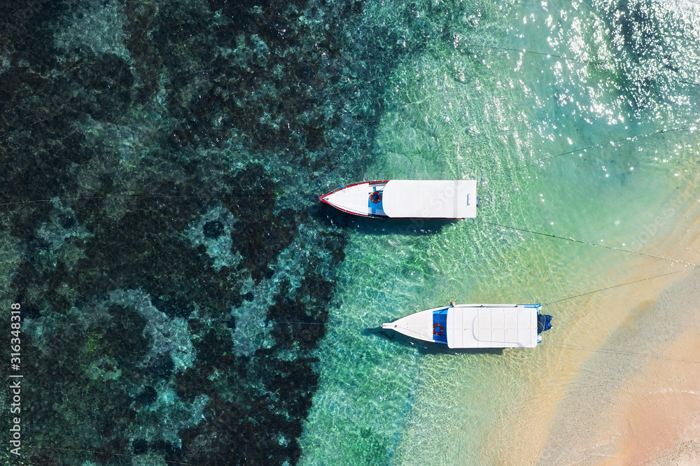 Boats on the water surface and beach from top view. Azure water background from drone. Summer seascape from air. Travel - image Boats on the water surface and beach from top view. Azure water background from drone. Summer seascape from air. Travel - image