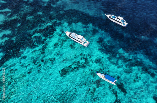 Boats on the water surface from top view. Azure water background from drone. Summer seascape from air. Travel - image © biletskiyevgeniy.com