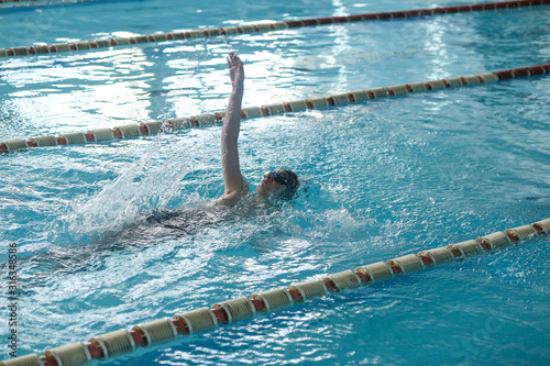 A teenager is swimming in a sports pool