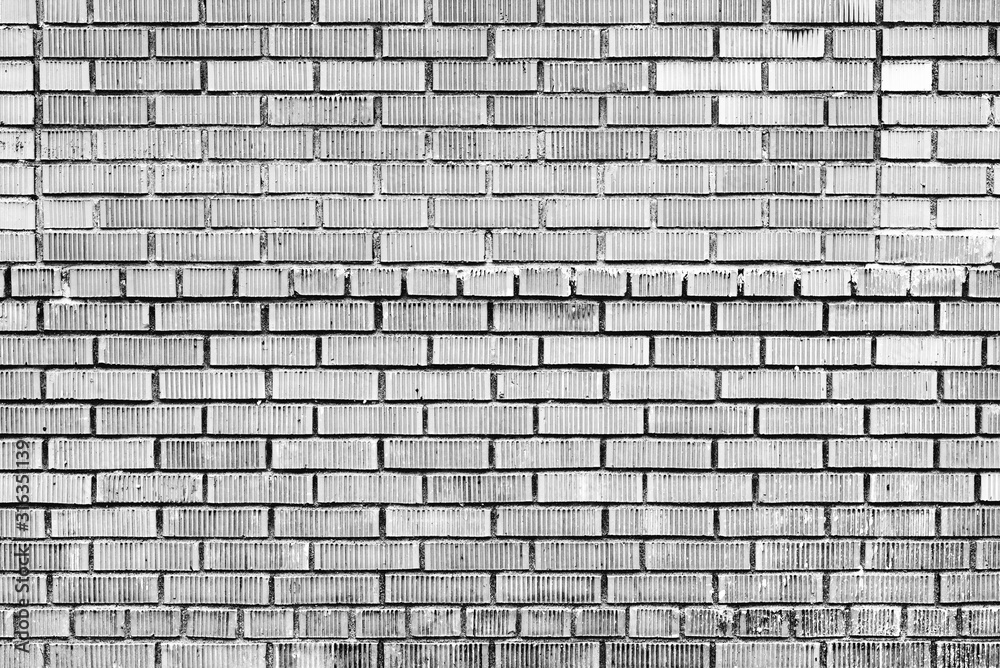 Obraz premium Texture of a brick wall with cracks and scratches which can be used as a background