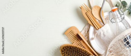 Set of eco friendly bamboo cutlery, mesh shopping bag, massage brush, glass bottle, bamboo toothbrush, wooden hair comb. Zero waste concept. Sustainable lifestyle. Eco store banner mockup