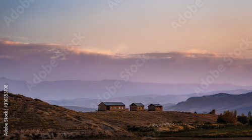 Mountain valley with houses on top of hill at sunset  Uzbekistan