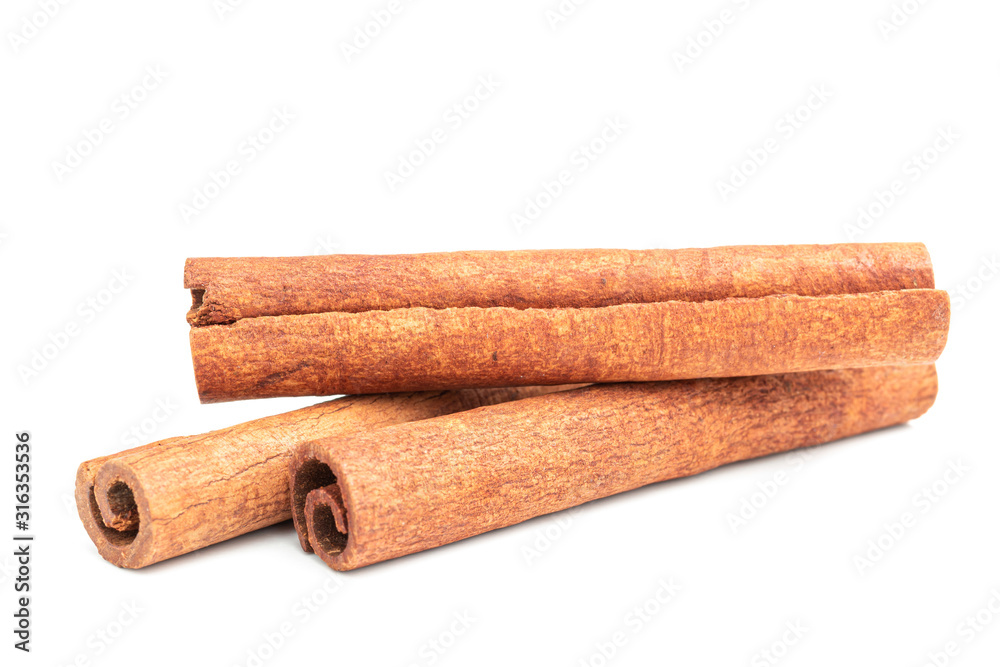 Cinnamon sticks isolated on white background, close-up view Cinnamon sticks isolated on white background, close-up view