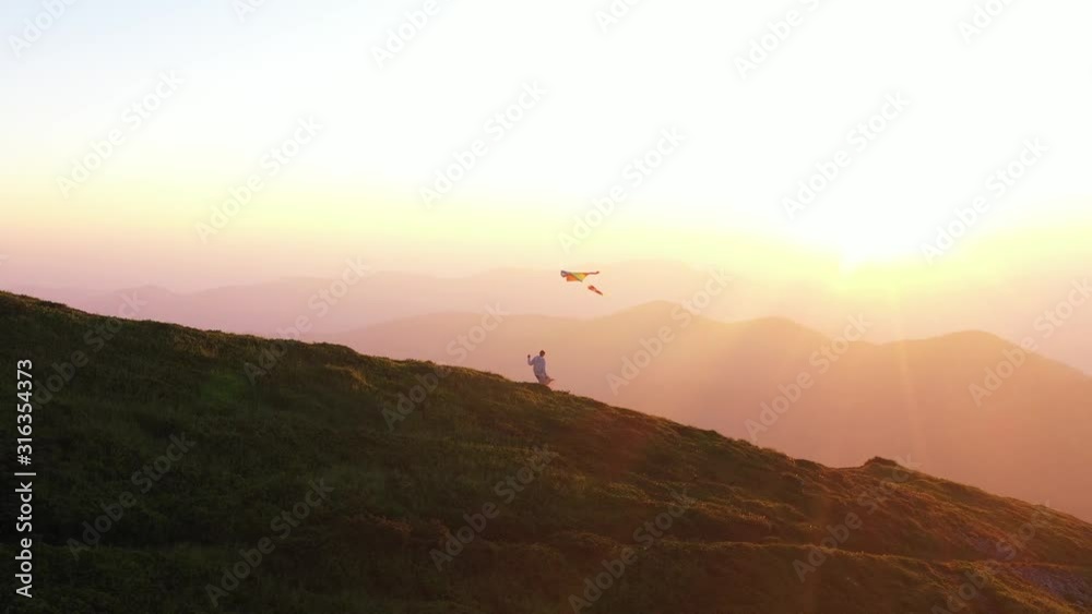Woman with kite walking on top of mountain amazing view outdoor girl happiness happy landscape hiking sky meadow grass sunlight free travel relax active wind slow motion Woman with kite walking on top of mountain amazing view outdoor girl happiness happy landscape hiking sky meadow grass sunlight free travel relax active wind slow motion