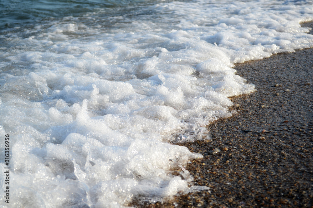 Obraz premium Sea foam at seashore
