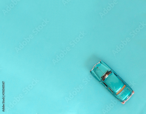 Blue car on a blue background with space copying. Car in retro style.