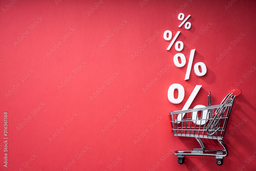 Sale Percents Falling Into Shopping Cart - obrazy, fototapety, plakaty 