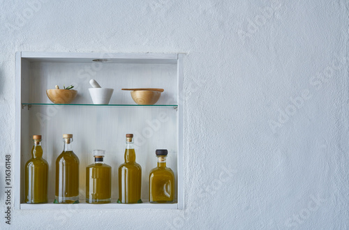fresh harvest newolive oil hous home design wall shelf oils three bottles shelf food cooking mediterranean natuorganic toscany beauty country house healthy stylish white copy space kitchen barn greece