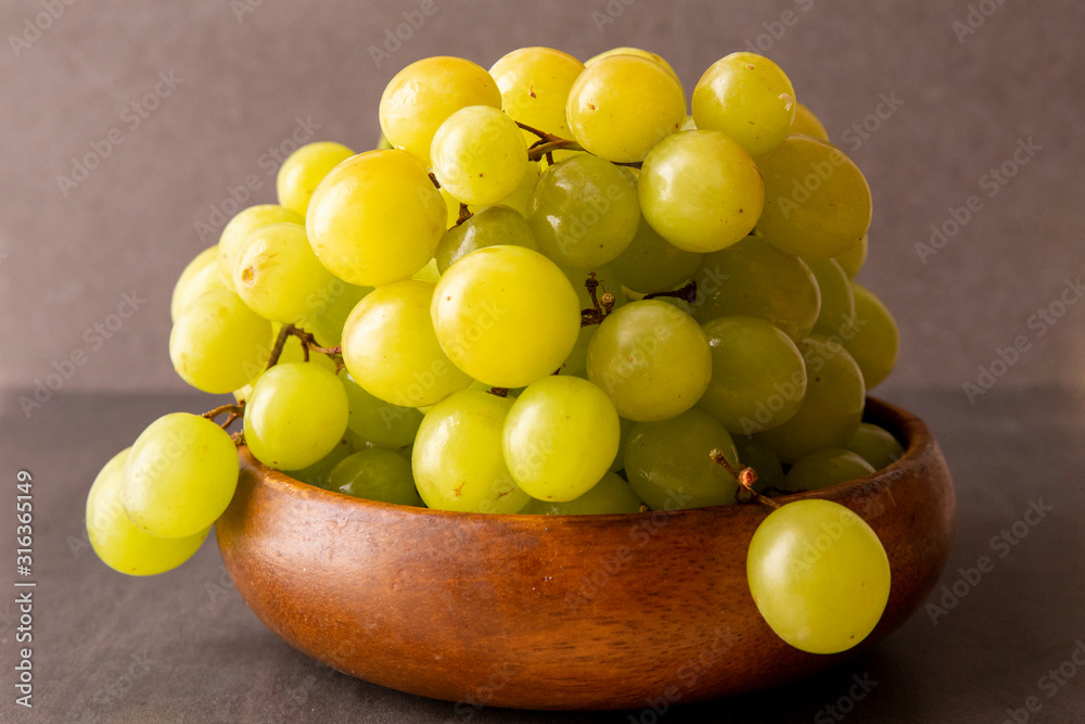 Green grapes in the wooden bowl
