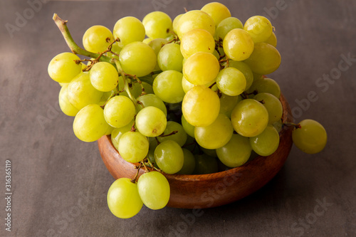 Green grapes in the wooden bowl