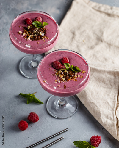 Raspberry banana smoothie with walnuts and granola