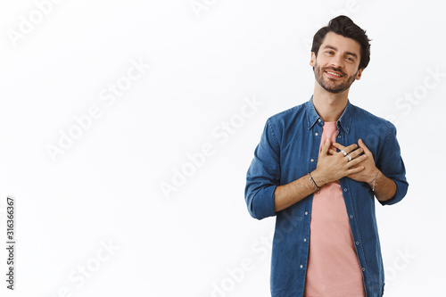 Canvastavla Charming young handsome man receive touching beautiful gift, press hands to hear