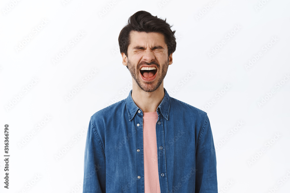 Boyfriend whining and complaining like baby, screaming out loud looking frustrated and upset, crying, squinting and frowning feeling distressed, standing unhappy over white background Boyfriend whining and complaining like baby, screaming out loud looking frustrated and upset, crying, squinting and frowning feeling distressed, standing unhappy over white background