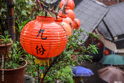 Asian lantern hanged in shopping street area in rainy day, Jiofen, Taiwan. Translation : Jiufen.