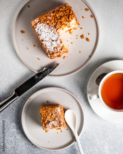 Piece of sour cream cake on white background