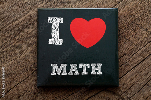 I Love Math written on black note with wood background