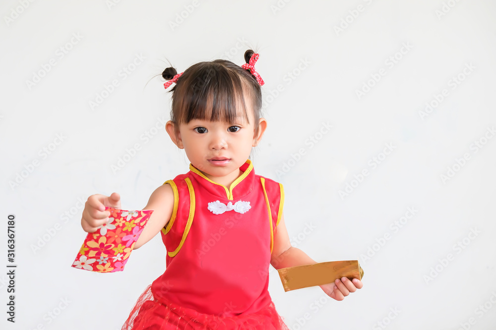 Chinese New Year festival concept, Portrait image of 1-2 yeas old baby. Happy Asian Chinese 's baby girl in the red clothes. She holding a pocket money gift in her hand. On white background. Chinese New Year festival concept, Portrait image of 1-2 yeas old baby. Happy Asian Chinese 's baby girl in the red clothes. She holding a pocket money gift in her hand. On white background.