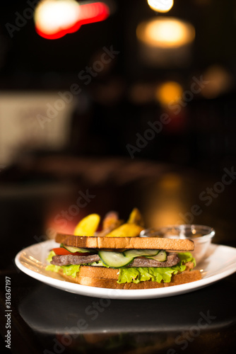 sandwich with beckon and fried potatoes