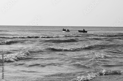 two fishing boats at sea, wave © Ella