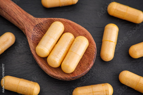 Boswellia capsules in a wooden spoon photo