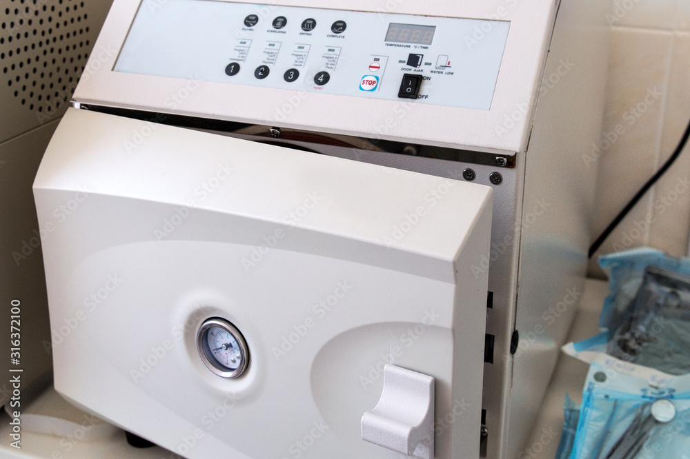Autoclave with medical instruments in sterilization room in clinic Autoclave with medical instruments in sterilization room in clinic
