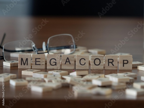 megacorp concept represented by wooden letter tiles photo