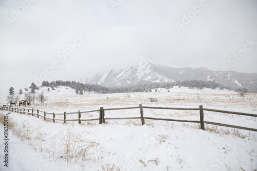 Long run of fence in a snowy landscape near Denver, Colorado