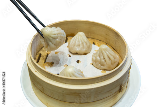 Chopstick on Xiao Long Pao, chinese food on white isolated.