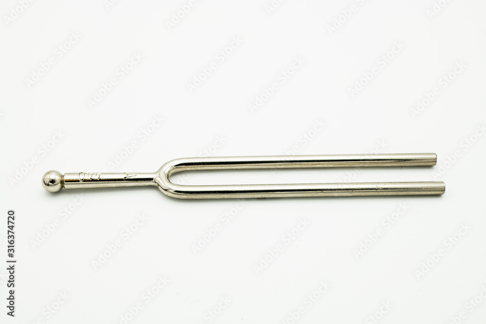 A tuning fork 440 Hz on a white background A tuning fork 440 Hz on a white background