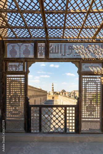 Passage surrounding the Mosque of Ibn Tulun framed by interleaved wooden perforated wall - Mashrabiya - Medieval Cairo, Egypt photo
