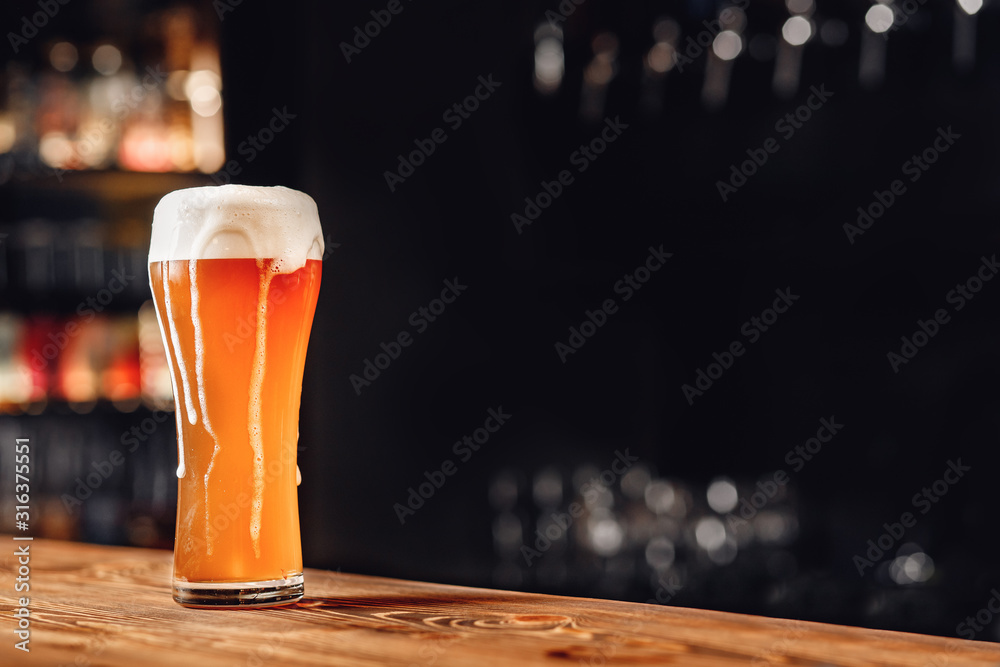 Fresh light beer with foam wooden pub counter, dark background - obrazy, fototapety, plakaty 