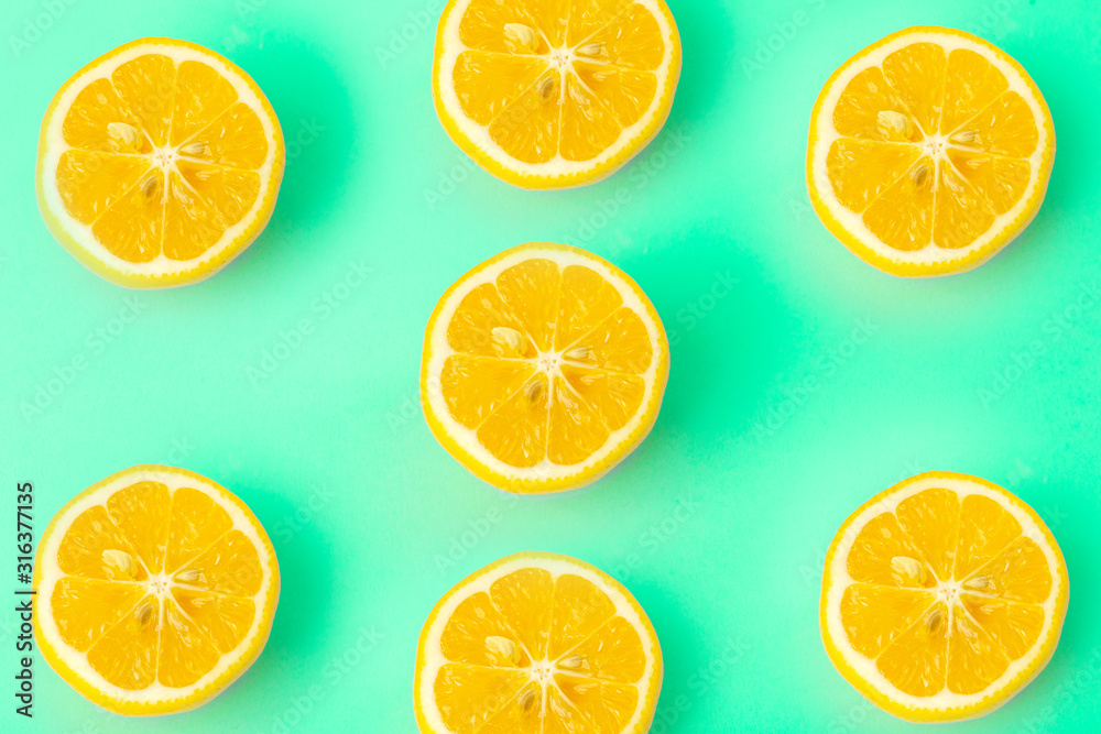 Summer and vitamins background. Lemon on a green background, minimal food concept Summer and vitamins background. Lemon on a green background, minimal food concept