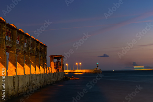 Pier and lighthouse at Drapetsona near Piraeus port photo