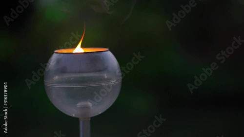 Glittering golden bokeh of burning candles glowing in glass lantern at dark night with full moon. Concept with Buddhism and peace. 